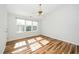 Sunlit bedroom with neutral walls, wood-look flooring and a ceiling fan at 3615 Ramblewood Ave, Durham, NC 27713