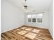 Sunlit bedroom with neutral walls, wood-look flooring and a ceiling fan at 3615 Ramblewood Ave, Durham, NC 27713