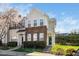Charming townhome with brick accents, green door, and blossoming tree at 3615 Ramblewood Ave, Durham, NC 27713