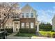 Charming townhome with brick accents, green door, and blossoming tree at 3615 Ramblewood Ave, Durham, NC 27713