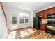 Bright kitchen features wood cabinets, black appliances and wood-look flooring and door to the exterior at 3615 Ramblewood Ave, Durham, NC 27713