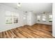 Open concept living room with hardwood floors, light fixtures, and natural light at 3615 Ramblewood Ave, Durham, NC 27713