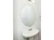 Neat powder room with pedestal sink, modern fixtures, and round mirror at 3615 Ramblewood Ave, Durham, NC 27713