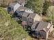 Aerial view of houses and community, surrounded by lush greenery and mature trees at 4 Applewood Sq, Durham, NC 27713
