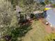 Backyard aerial view with green lawn, deck, mature trees, and landscaping, providing a private outdoor space at 4 Applewood Sq, Durham, NC 27713