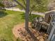 Backyard with mature trees and a deck with rocking chairs at 4 Applewood Sq, Durham, NC 27713