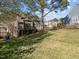 Expansive backyard with lush grass, trees, and view of neighboring houses at 4 Applewood Sq, Durham, NC 27713