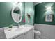 A bathroom featuring an oval mirror, single sink vanity, and a framed art print at 4 Applewood Sq, Durham, NC 27713
