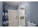 Bathroom and shower with blue wall paint at 4 Applewood Sq, Durham, NC 27713