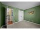 A bedroom featuring neutral carpet, light-filtering blinds, closet, and green colored walls at 4 Applewood Sq, Durham, NC 27713