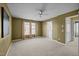 Spacious bedroom with neutral carpet, ceiling fan and warm mocha brown wall paint at 4 Applewood Sq, Durham, NC 27713