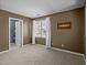 Bedroom with window, white blinds, mocha brown wall paint and open door at 4 Applewood Sq, Durham, NC 27713