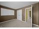 Bedroom with neutral carpet, mocha brown wall paint and open doors at 4 Applewood Sq, Durham, NC 27713
