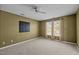 Bedroom with beige carpet, a ceiling fan, windows and mocha brown wall paint at 4 Applewood Sq, Durham, NC 27713