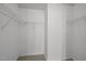Walk-in closet with metal shelving and neutral carpeting and white wall paint at 4 Applewood Sq, Durham, NC 27713