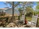 Relaxing outdoor deck with seating and a view of lush greenery and home exterior at 4 Applewood Sq, Durham, NC 27713