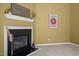 Close-up of a cozy fireplace with mantel, artwork, and stylish decorations in a living room at 4 Applewood Sq, Durham, NC 27713