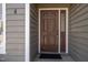 Close-up of a well-maintained front door with sidelight and house number against neutral siding at 4 Applewood Sq, Durham, NC 27713