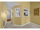 Hallway with views of the kitchen, neutral paint, and convenient pass-through windows at 4 Applewood Sq, Durham, NC 27713