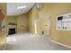 Spacious living room featuring a fireplace, skylight, high ceilings, and neutral carpeting at 4 Applewood Sq, Durham, NC 27713