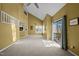 Open living room showcasing high ceilings, fireplace, access to deck, and an open layout at 4 Applewood Sq, Durham, NC 27713