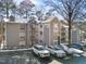 View of the condo exterior, showcasing parking, building details and architectural design at 4631 Timbermill Ct # 301, Raleigh, NC 27612