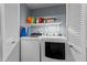 Efficient laundry area with a washer, dryer, and shelving for storage at 4631 Timbermill Ct # 301, Raleigh, NC 27612