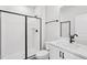 Bathroom featuring a walk-in shower with black trim and white vanity at 4706 Cypress Tree Ln, Raleigh, NC 27612
