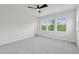 Spacious bedroom with three large windows and a ceiling fan at 4706 Cypress Tree Ln, Raleigh, NC 27612