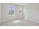 Bright bedroom with carpet, two windows, and neutral paint at 4706 Cypress Tree Ln, Raleigh, NC 27612