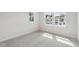 Cozy bedroom featuring carpet, two windows, and neutral paint at 4706 Cypress Tree Ln, Raleigh, NC 27612