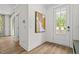 Entryway features a glass door, artwork and a hall tree with storage at 4706 Cypress Tree Ln, Raleigh, NC 27612