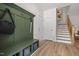 Entryway with hall tree, storage, and stairs leading to the upper level at 4706 Cypress Tree Ln, Raleigh, NC 27612