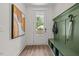 Welcoming entryway with a hall tree, a bench, and modern artwork at 4706 Cypress Tree Ln, Raleigh, NC 27612