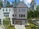 Modern townhome with neutral siding, a two-car garage, and manicured lawn at 4706 Cypress Tree Ln, Raleigh, NC 27612
