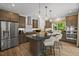 Gourmet kitchen boasts stainless steel appliances, a large island, and custom cabinetry at 4706 Cypress Tree Ln, Raleigh, NC 27612