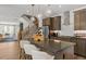 Open floorplan between kitchen and living room with seating at the island and modern finishes at 4706 Cypress Tree Ln, Raleigh, NC 27612
