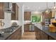 Well-equipped kitchen features a gas cooktop, double ovens, and ample counter space at 4706 Cypress Tree Ln, Raleigh, NC 27612