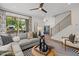 Another view of cozy living area with modern stairwell, great natural light, and comfortable seating at 4706 Cypress Tree Ln, Raleigh, NC 27612
