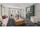 Bright living room featuring a modern fireplace, stylish light fixture, and comfortable seating area at 4706 Cypress Tree Ln, Raleigh, NC 27612
