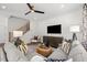 Inviting living room featuring modern decor, plush seating, and stylish ceiling fan at 4706 Cypress Tree Ln, Raleigh, NC 27612