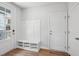 Mud room with built-in bench seating, shoe storage, and hooks for hanging coats at 4706 Cypress Tree Ln, Raleigh, NC 27612