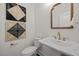 Well-appointed powder room with stylish fixtures and unique wall art at 4706 Cypress Tree Ln, Raleigh, NC 27612