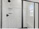 Walk-in shower with grey hexagon tile at 4706 Cypress Tree Ln, Raleigh, NC 27612