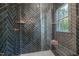 Elegant shower featuring beautiful tilework, built-in shelves, and a window at 4706 Cypress Tree Ln, Raleigh, NC 27612