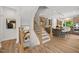 Stylish staircase leading to a well-equipped kitchen with stainless steel appliances at 4706 Cypress Tree Ln, Raleigh, NC 27612
