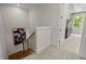 Bright stairwell with hardwood stairs, black railings, leading to a carpeted landing and featuring a modern art piece at 4706 Cypress Tree Ln, Raleigh, NC 27612