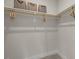 Organized walk-in closet features shelving, clothing rods, and storage bins at 4706 Cypress Tree Ln, Raleigh, NC 27612