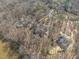 Intimate aerial view featuring homes nestled amongst mature trees along a glistening lake at 4808 Clubview Ct, Fuquay Varina, NC 27526