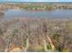 Breathtaking aerial view of the home, revealing its private setting with lake access and lush surrounding landscape at 4808 Clubview Ct, Fuquay Varina, NC 27526